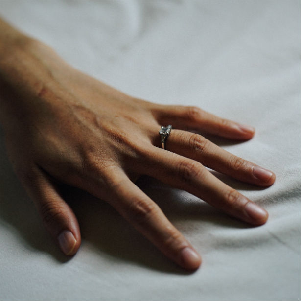 emerald cut vs cushion cut woman's hand
