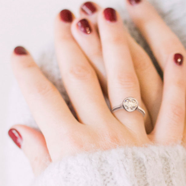 woman's hands wearing bezel setting