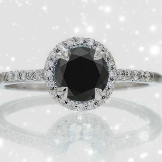 black diamond engagement ring on pink background