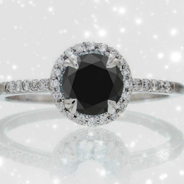 black diamond engagement ring on pink background