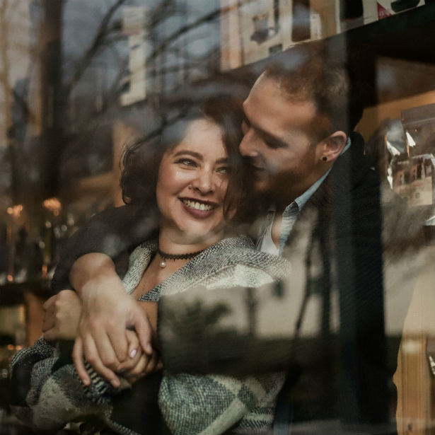 couple embracing in window