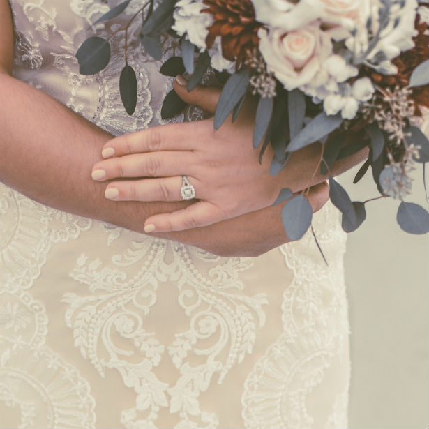 cushion vs asscher woman in wedding dress holding bouquet