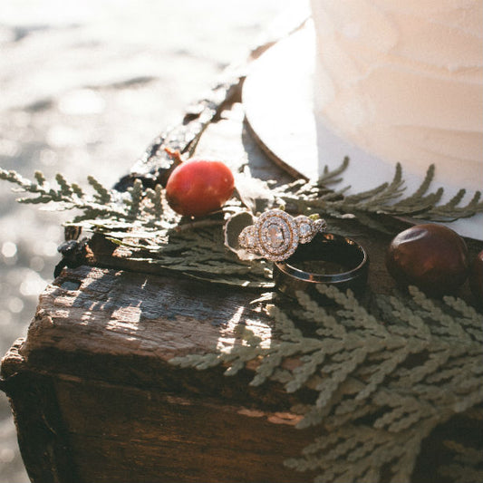 nature inspired engagement ring next to cake