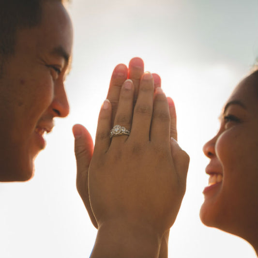 unique engagement rings couple touching hands