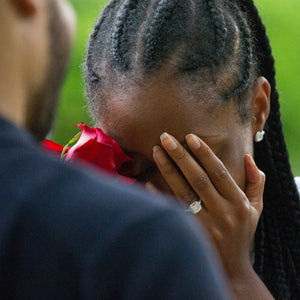 woman covering face wearing engagement ring with canadian diamonds